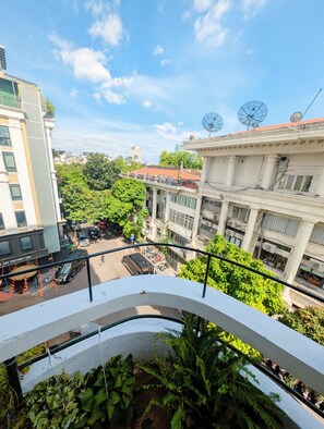 A view from a balcony overlooking a cityscape with buildings, greenery, and a clear sky. - Maison Maravelle Hotel (Ha Noi)