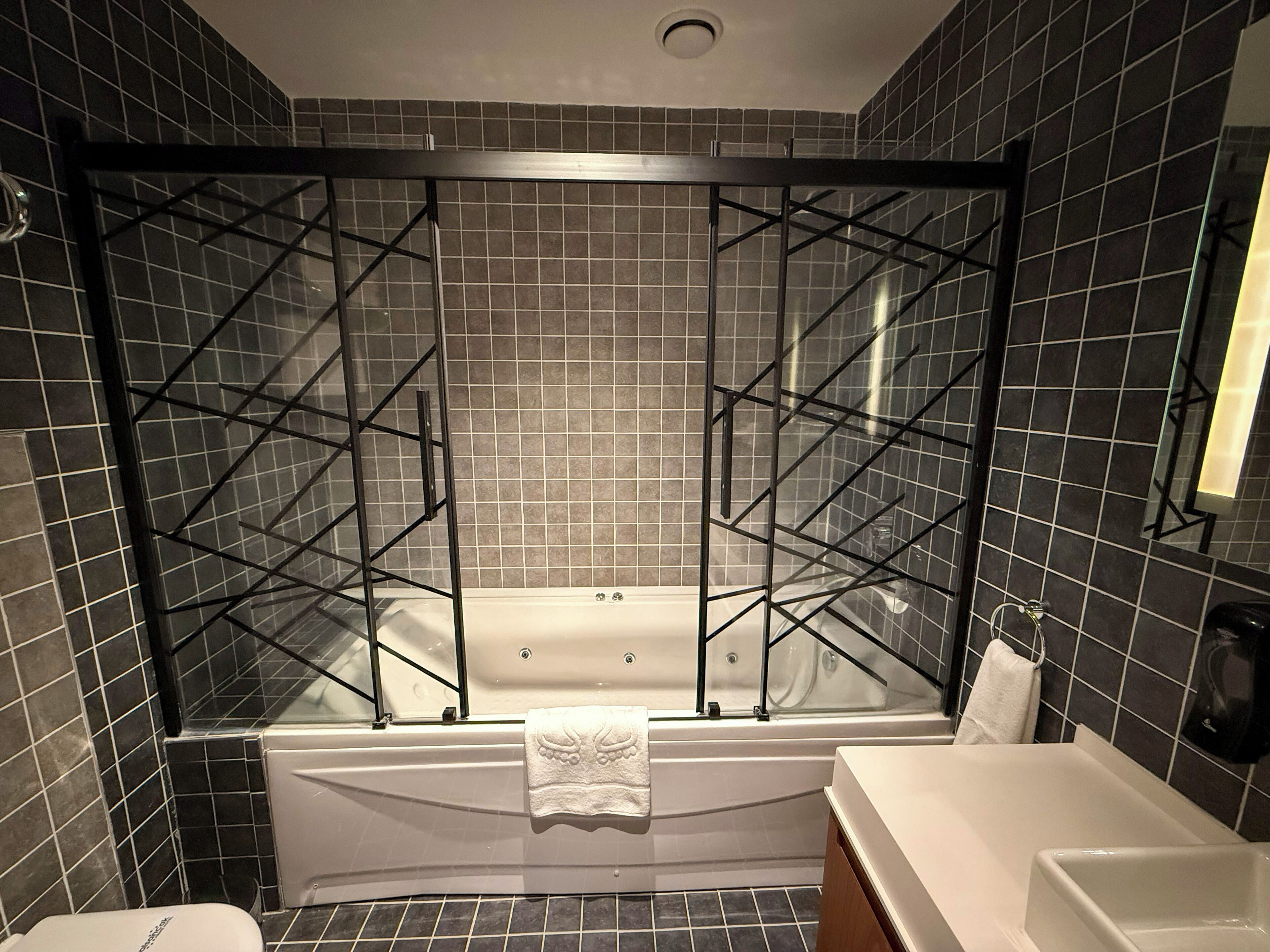A modern bathroom with a freestanding bathtub, a separate shower area with a glass enclosure, and a vanity with a sink.