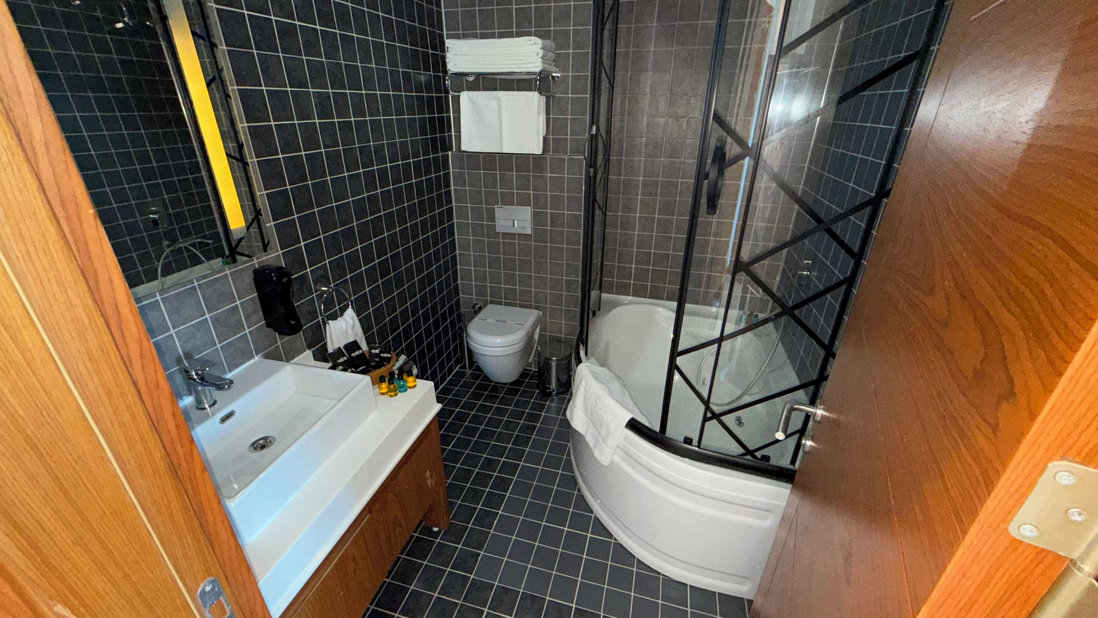 A bathroom with a bathtub, toilet, and shower.