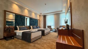 A hotel room with a large bed, a desk, a chair, a TV, and a large mirror. - ALSANCAK PRIME HOTEL KONYA  (Konya)
