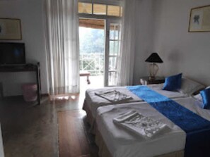 Deluxe Quadruple Room, Pool View | Desk