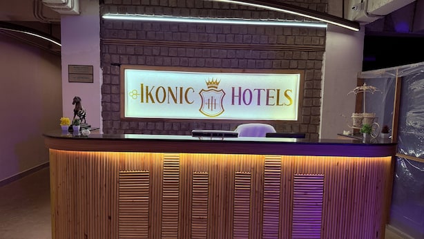 A reception desk with a sign reading "IKONIC HOTELS" and a horse statue. - Ikonic Hotel - Bhushi Dam Lonavala (Lonavala)