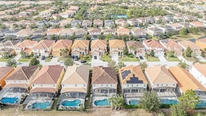 A residential area with multiple houses, some with visible swimming pools.