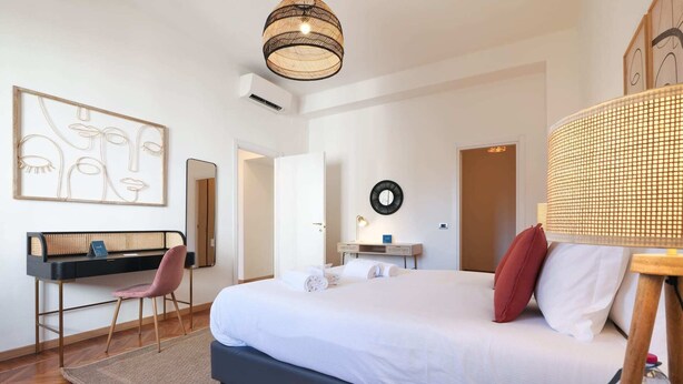 A modern hotel room with a bed, desk, chair, and artwork on the wall. - Sweett | Fontana - Two Bedroom Apartment, Sleeps 5 (Milano)