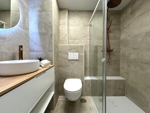 Shower, hair dryer, towels, toilet paper