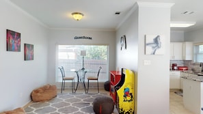 A compact living space with a dining area, a kitchenette, and a labeled 'GAMER ROOM'.