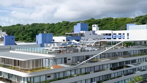 A modern building with multiple floors, large windows, and a flat roof. - Setai Yach (Joao Pessoa)