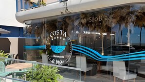 A restaurant with a coastal theme, featuring a logo with a wave and the name 'COSTA'. - Setai Yach (Joao Pessoa)