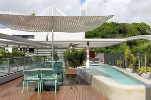 A rooftop deck with a pool, outdoor seating, and a covered area with a canopy. - Setai Yach (Joao Pessoa)