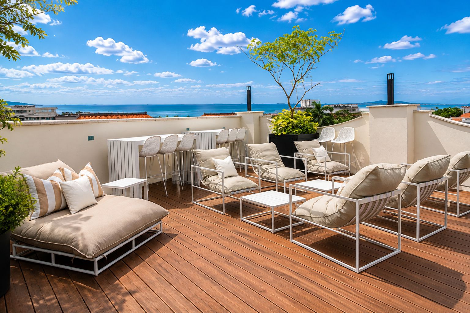 A rooftop terrace with outdoor seating, a view of the sea, and a potted plant.