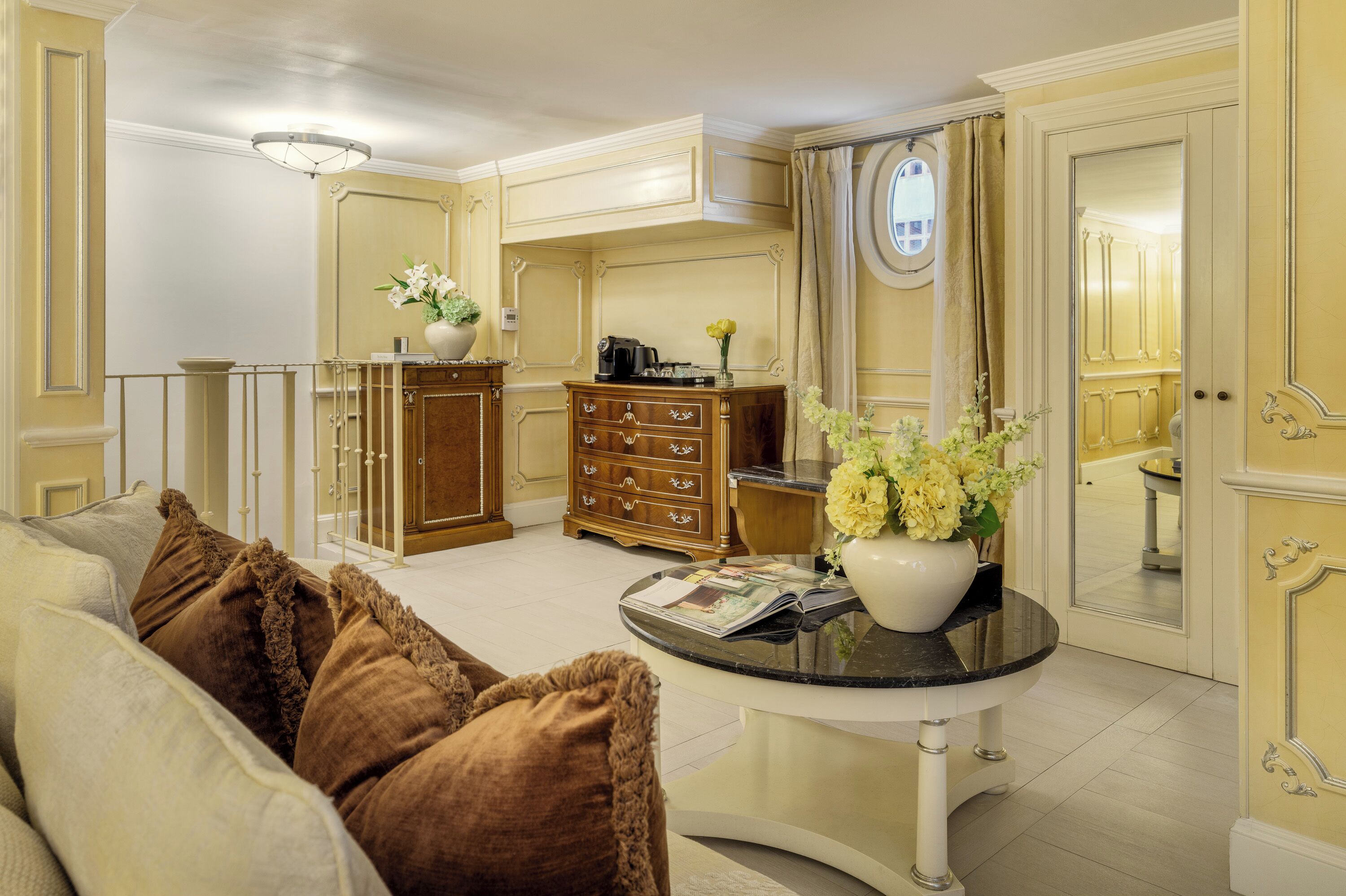 A well-lit living room with a sofa, a coffee table, and a cabinet.
