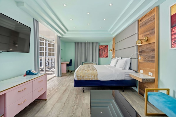 A modern hotel room with a bed, a desk, a TV, and a large window. - Abitta Condado by IHG (San Juan)