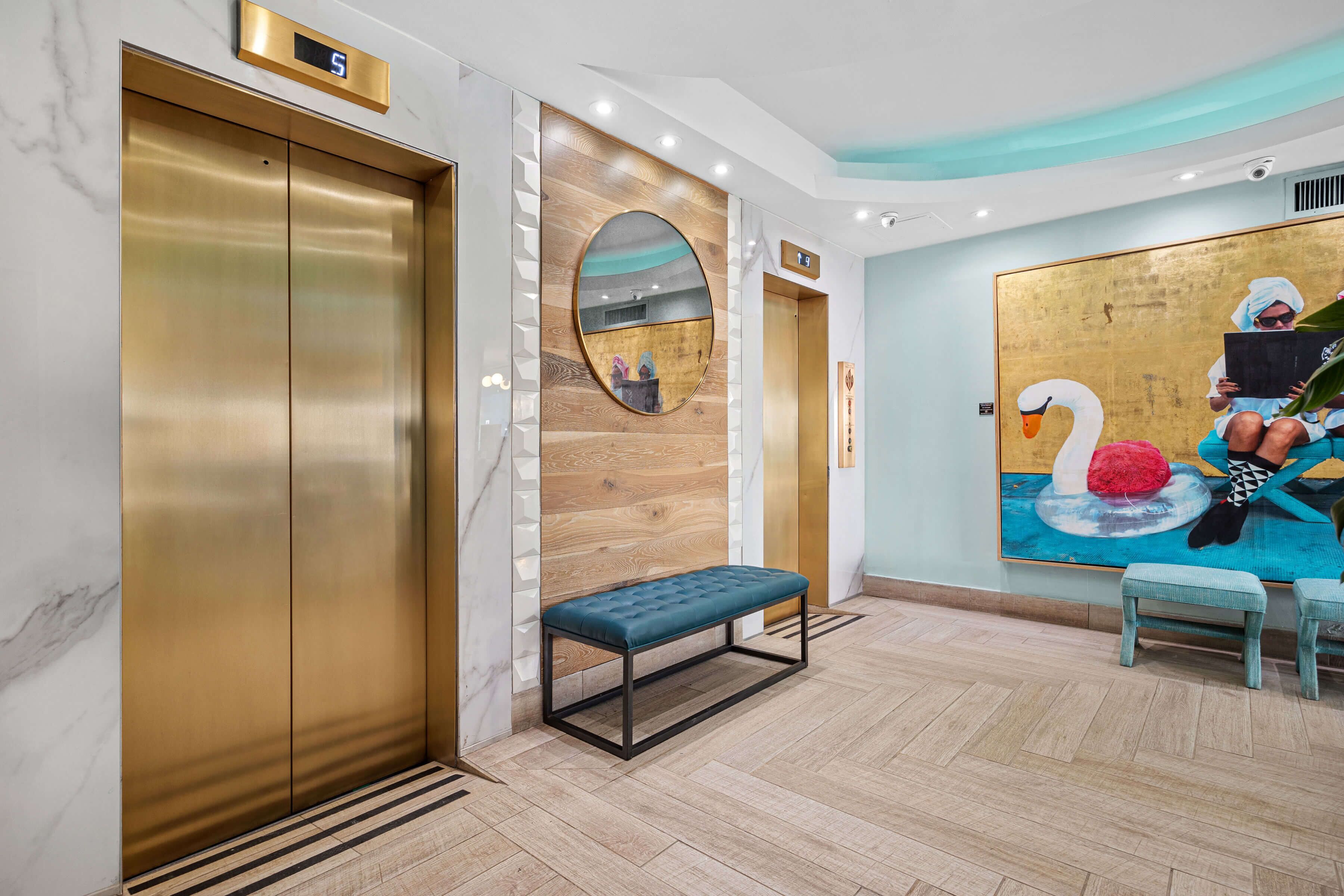 A modern elevator with a digital display, a wooden wall panel, and a bench.
