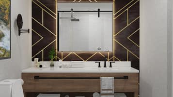 Un baño moderno con tocador, inodoro y ducha.