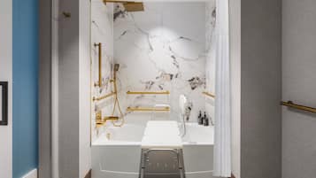 A modern bathroom with a marble wall, a bathtub, and a shower area.