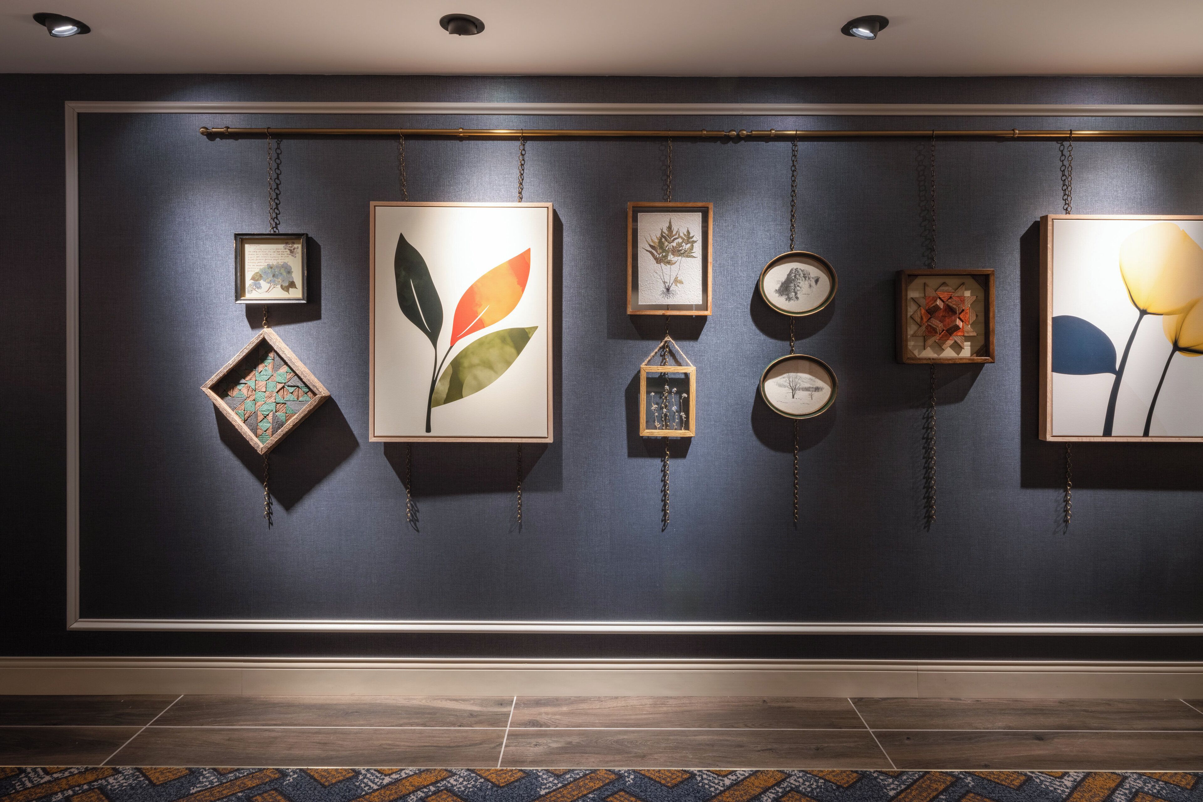 A wall with various framed artworks and decorative items.