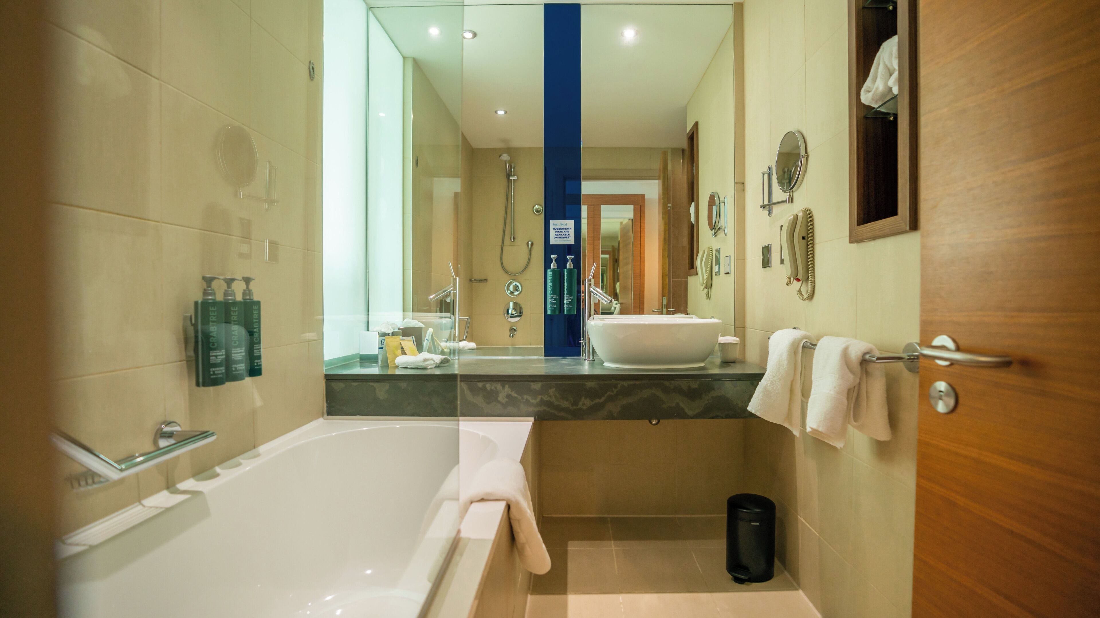 A modern bathroom with a bathtub, a sink, and a shower.