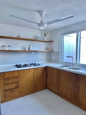 Fridge, microwave, stovetop, coffee/tea maker