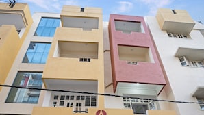 A multi-story building with a sign reading "AISHWARYA APARTMENT".