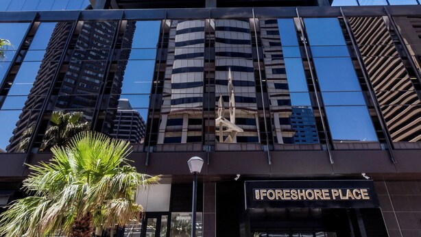 A modern building with a glass facade and a prominent entrance labeled "FORESHORE PLACE".