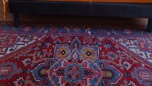 A bed with a blue headboard, two bedside tables with lamps, and a patterned rug. - Guest room on 1st floor of château (Hinacourt)