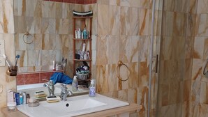 A bathroom with a marble vanity, a glass shower enclosure, and a mirror above the sink. - Guest room on 1st floor of château (Hinacourt)
