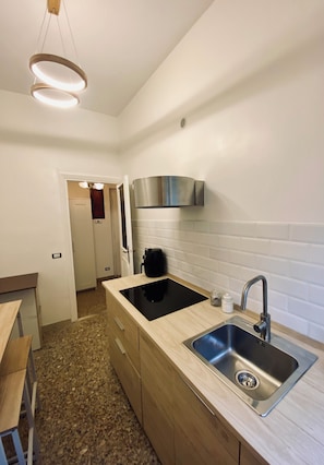 Fridge, microwave, stovetop, coffee/tea maker