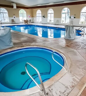 An indoor swimming pool with clear water, a tiled floor, and arched windows. - Charming Studio w/ Pool Access in Branson (Branson)