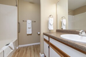 A bathroom with a sink, mirror, towel rack, and shower. - Charming Studio w/ Pool Access in Branson (Branson)