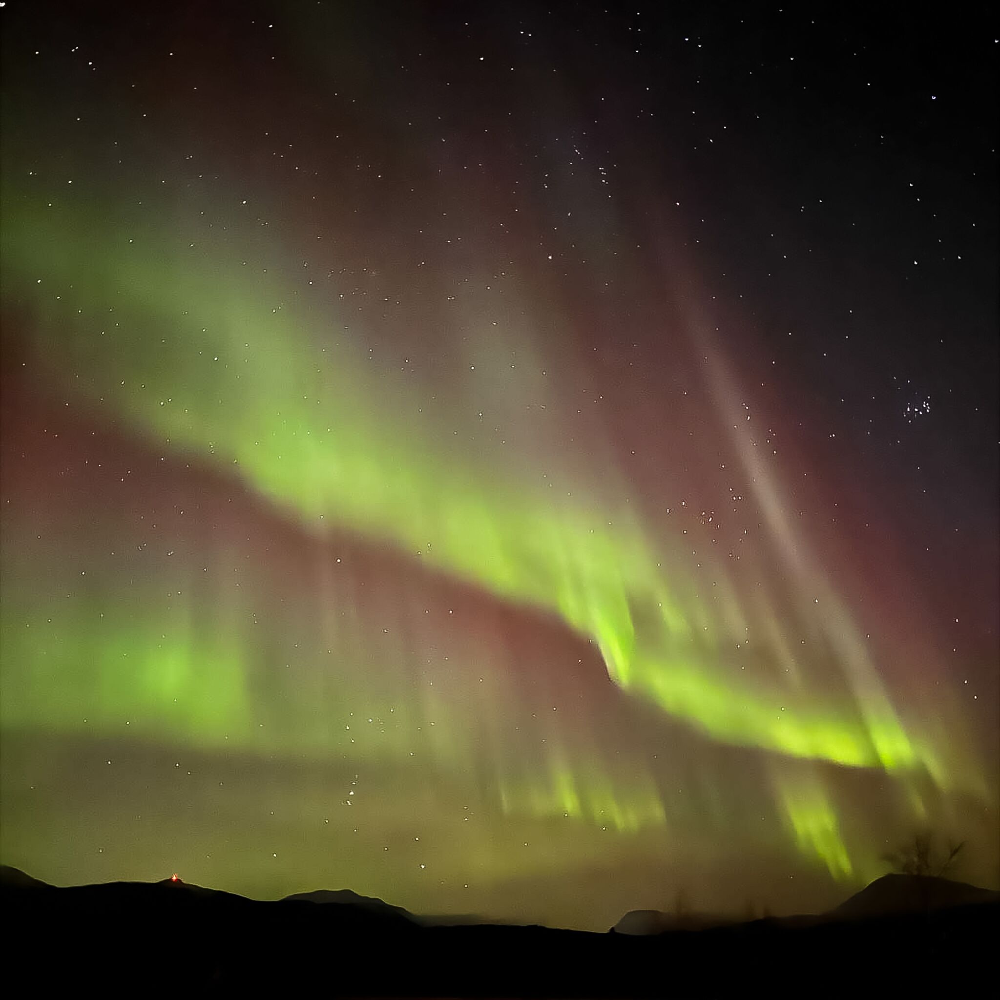 A night sky with visible stars and the aurora borealis.