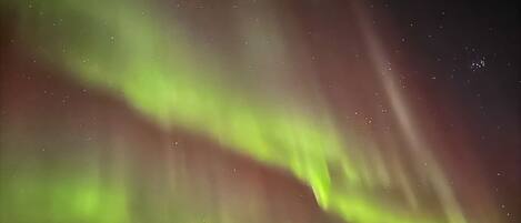 A night sky with visible stars and the aurora borealis.