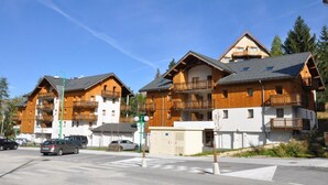 A row of wooden multi-story buildings with balconies, likely a hotel or resort. - 200m from resort center, terrace, balcony, tv, 35-50m², Les 2 Alpes (Les Deux Alpes)