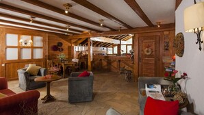 A rustic interior with wooden beams, stone flooring, and cozy seating areas. - Wifi, ski-in/ski-out & foot of the slopes, swimming pool, sauna, tv, ski locker, 37m², Valfréjus (Valfréjus)