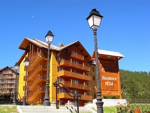 A multi-story building with balconies, labeled "Résidence VÉGA."