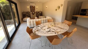 A modern dining area with a marble table, leather chairs, and a cozy seating arrangement. - Villa with swimming pool on the Angoulême golf course (Angoulême)