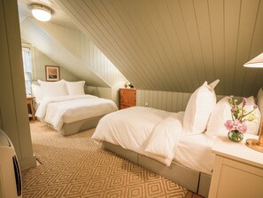 A bedroom with two beds, a dresser, and a nightstand. - Sawyer House (Nantucket)