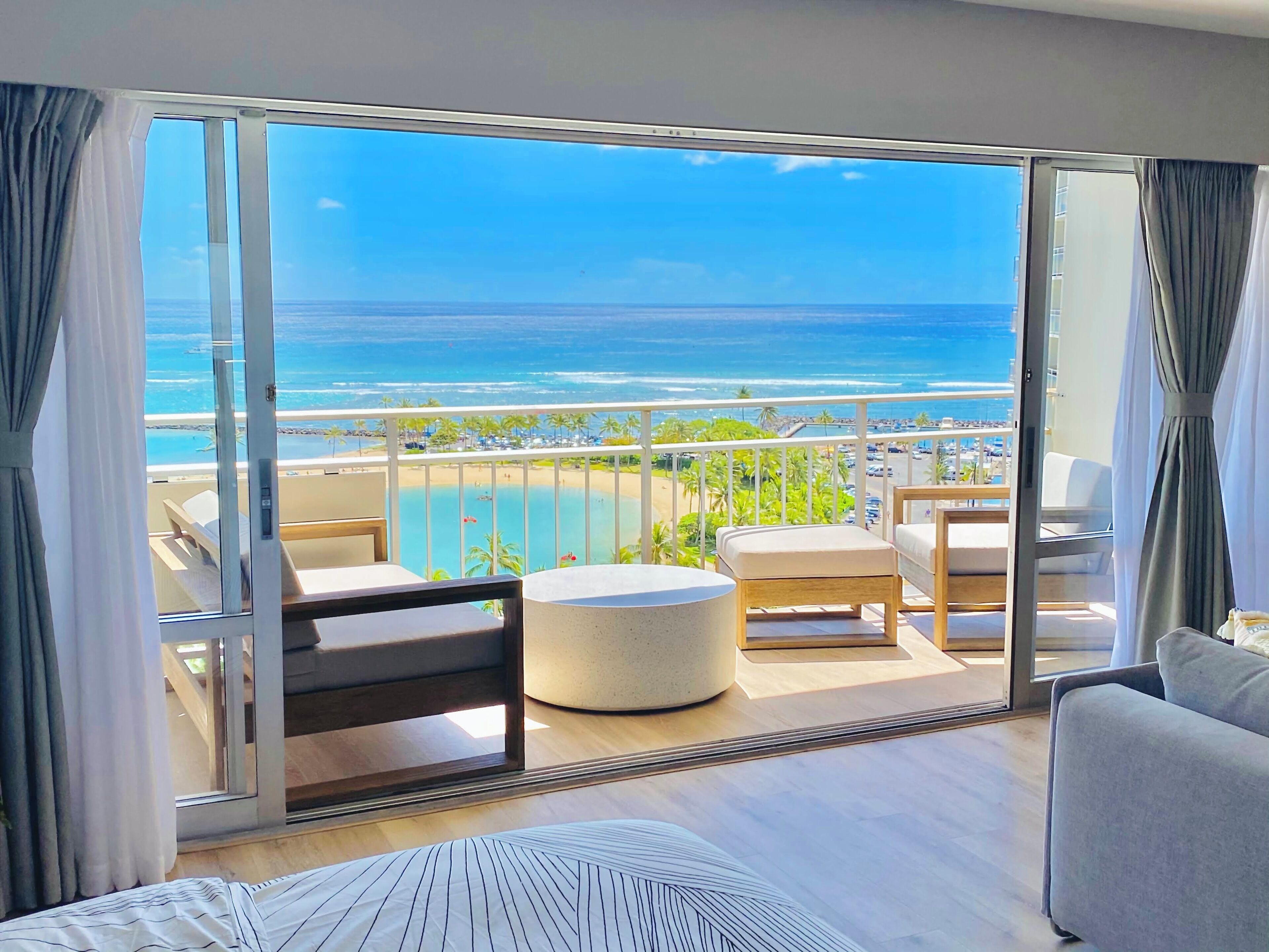 A balcony with a view of the ocean and beach.