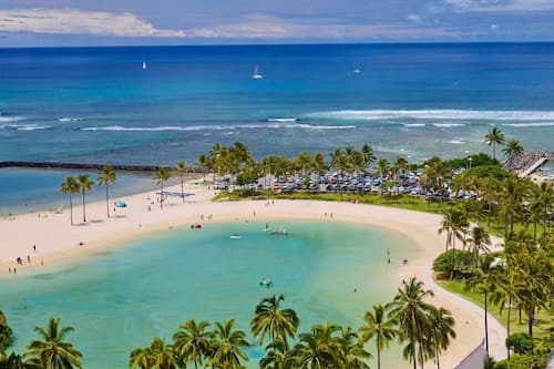 On the beach, white sand, beach umbrellas, beach towels