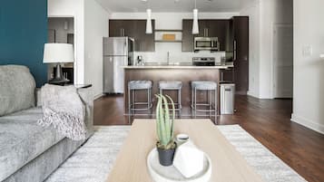 Apartment, 3 Bedrooms | Living area | 50-inch TV with digital channels