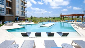 Seasonal outdoor pool, pool loungers - Landing Apartments Fort Worth - Charleston (Fort Worth)