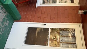 A white door with a window, a no smoking sign, and a brick wall. - Stoney River Lodge - Unit 4 - Eagle (Loveland)
