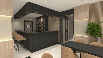 A modern bar area with a counter, stools, and a seating area with a table and chairs.