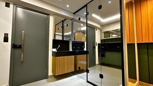 A modern kitchen with a wooden countertop, a built-in oven, and a glass partition. - Get one (Joao Pessoa)
