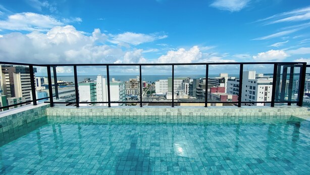 A rooftop infinity pool with a city view. - Flat Tambaú aproveite com sua família  (Joao Pessoa)