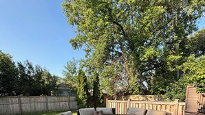 A deck with wicker furniture and a wooden deck floor. - Galactic Oasis Wonderful 5 bedroom theme home, Wi-Fi, king beds and smart tvs (Aurora)