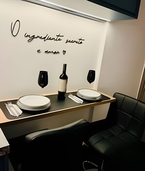 A modern bathroom with two sinks, a wine bottle, and a mirror.