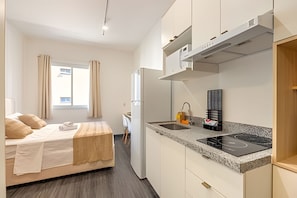 Comfort Apartment | Private kitchen | Microwave, cleaning supplies