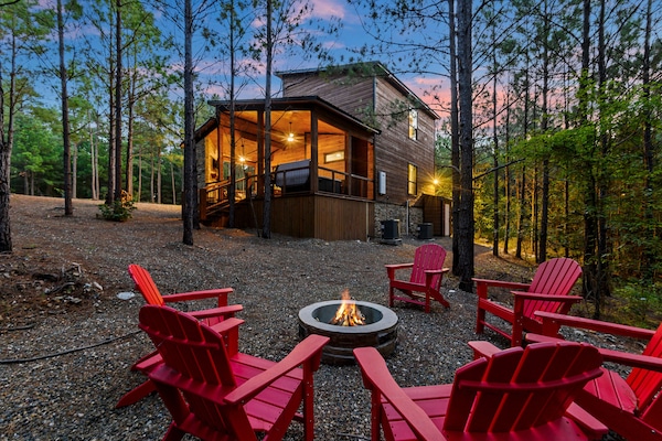 Red chairs, warm fire, glowing cabin dusk - Hochatown, OK.