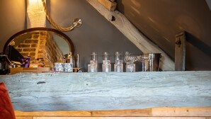 A rustic attic room with a wooden floor, a fur rug, and a mirror. - The Cocktail Lounge - sleeps 2 guests  in 1 bedrooms (Nantwich)