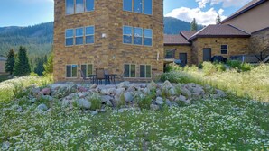 A stone building with multiple windows and a patio area with outdoor furniture. - Hot Tub, Pool Table & Fireplace: 5 Mi to Breck! (Blue River)
